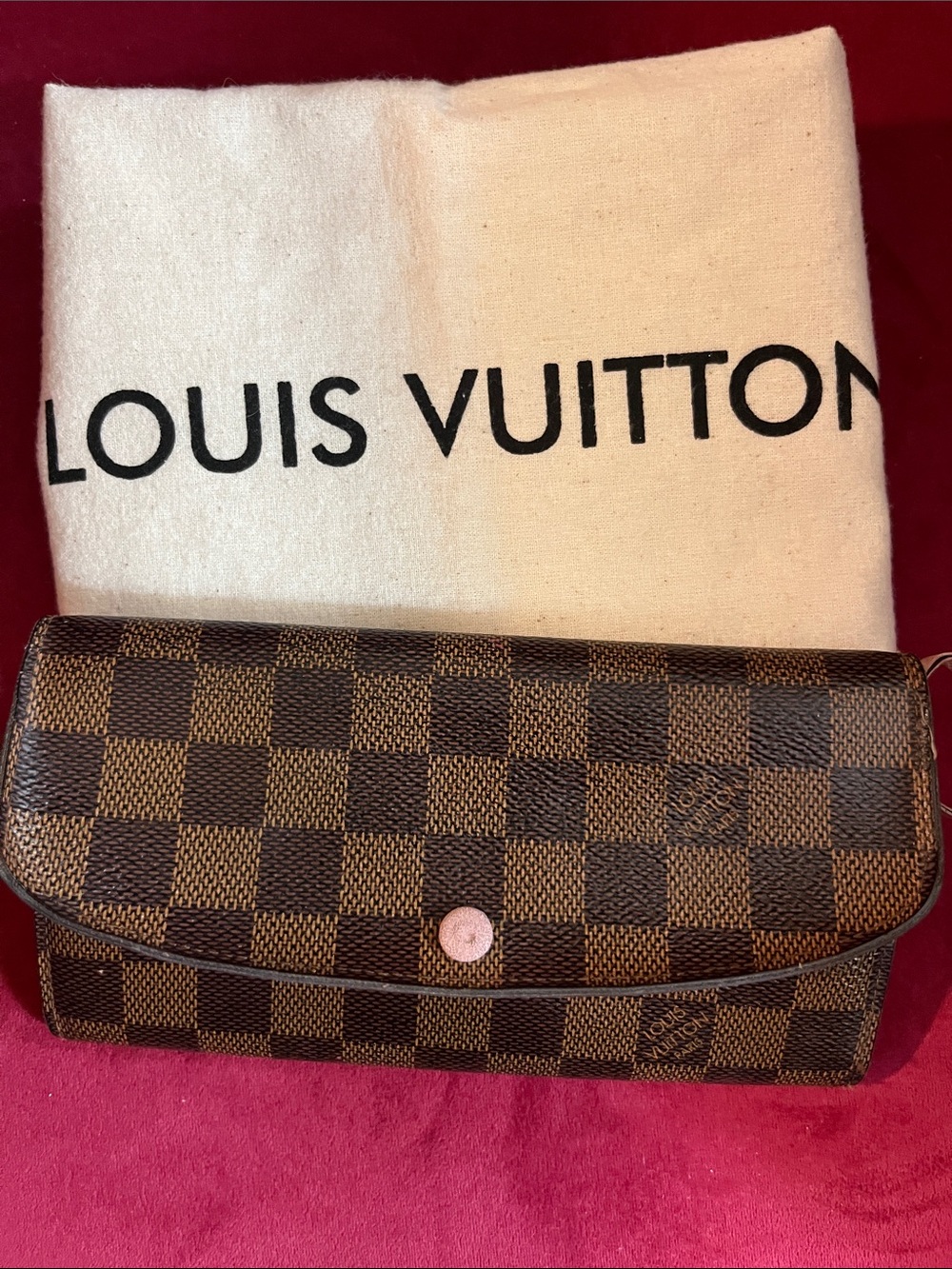 Louis Vuitton Emilie Wallet in Damier Ebène canvas features a sleek flap des